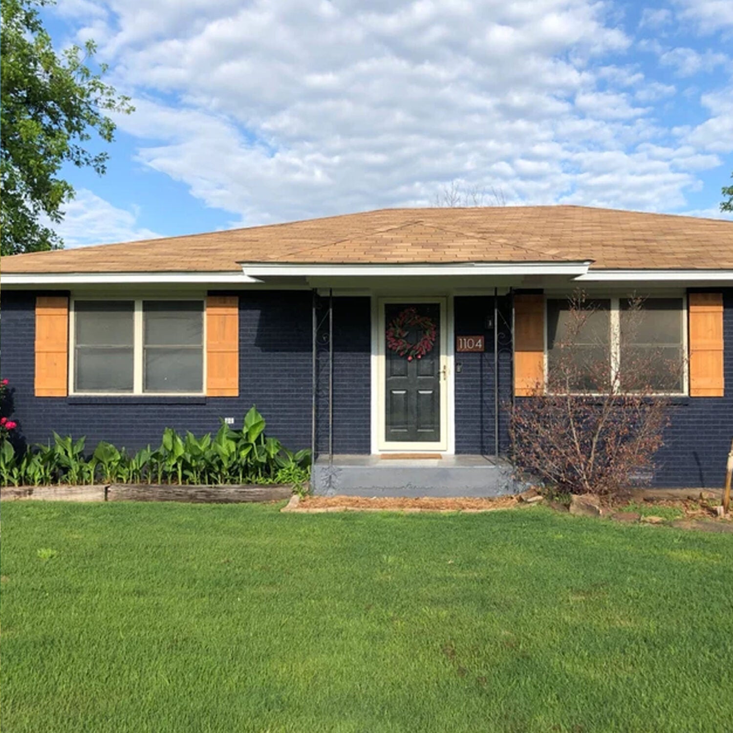 Cedar board and batten shutters on home